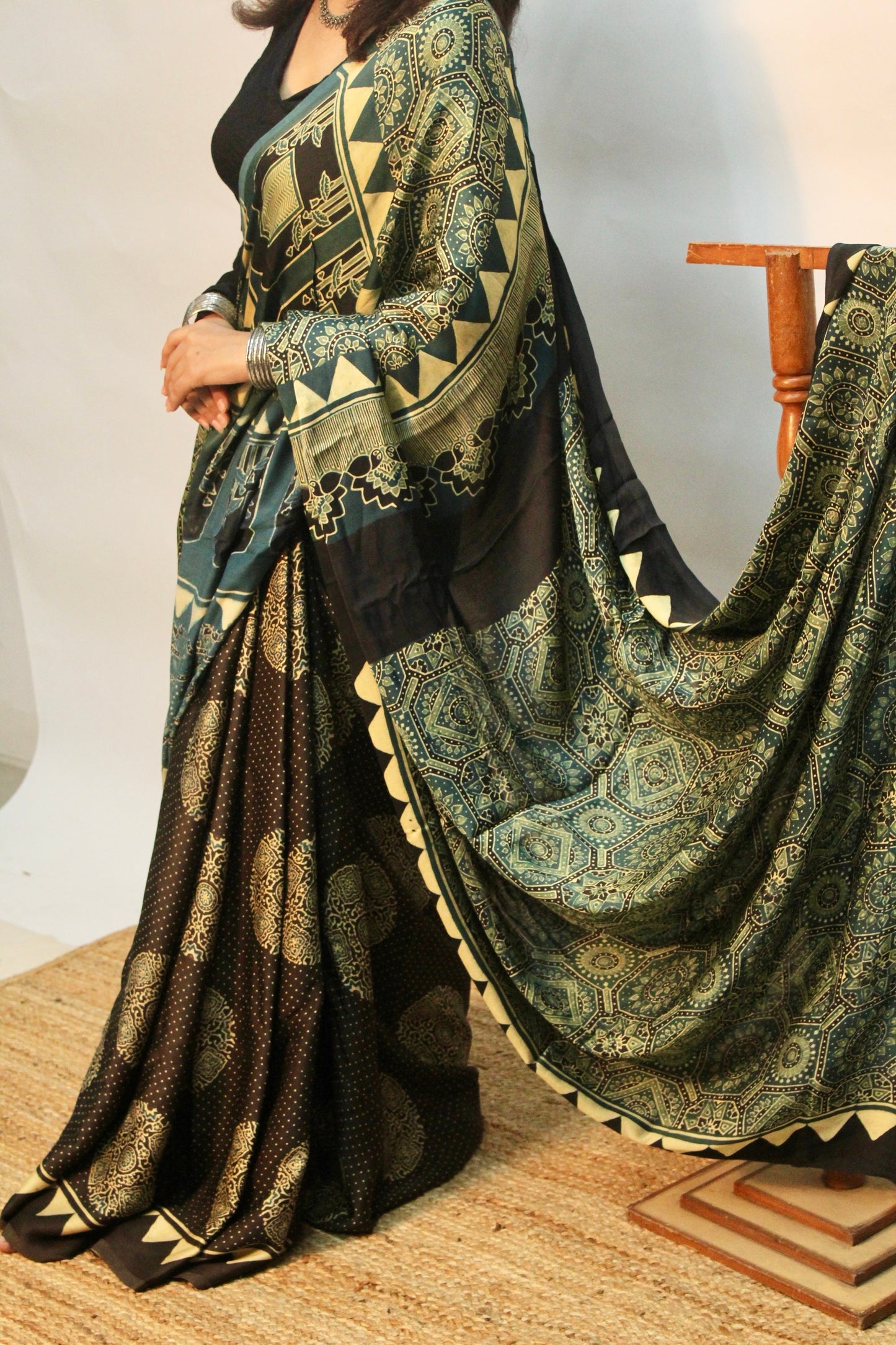Elegant teal blue Ajrakh saree in soft modal silk showcasing artisan block printing techniques
