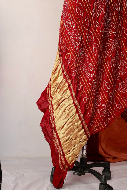 Traditional Bandhani Gajji silk saree in terracotta hues with a beautifully woven zari pallu