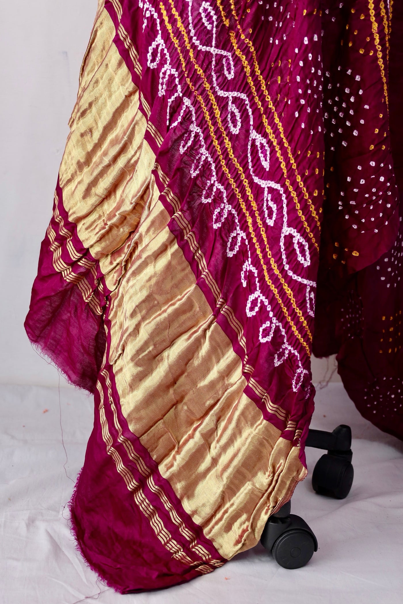 Handcrafted wine Gajji silk saree showcasing authentic Bandhani artistry with rich zari detailing