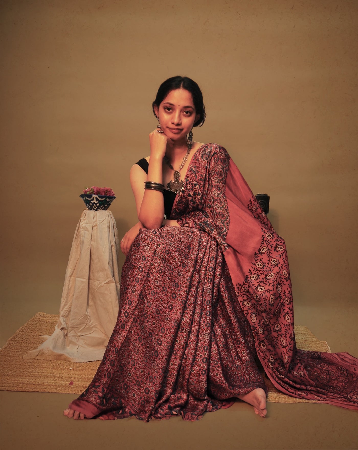 Elegant wine pink Ajrakh saree in modal silk showcasing skilled artisan block printing techniques