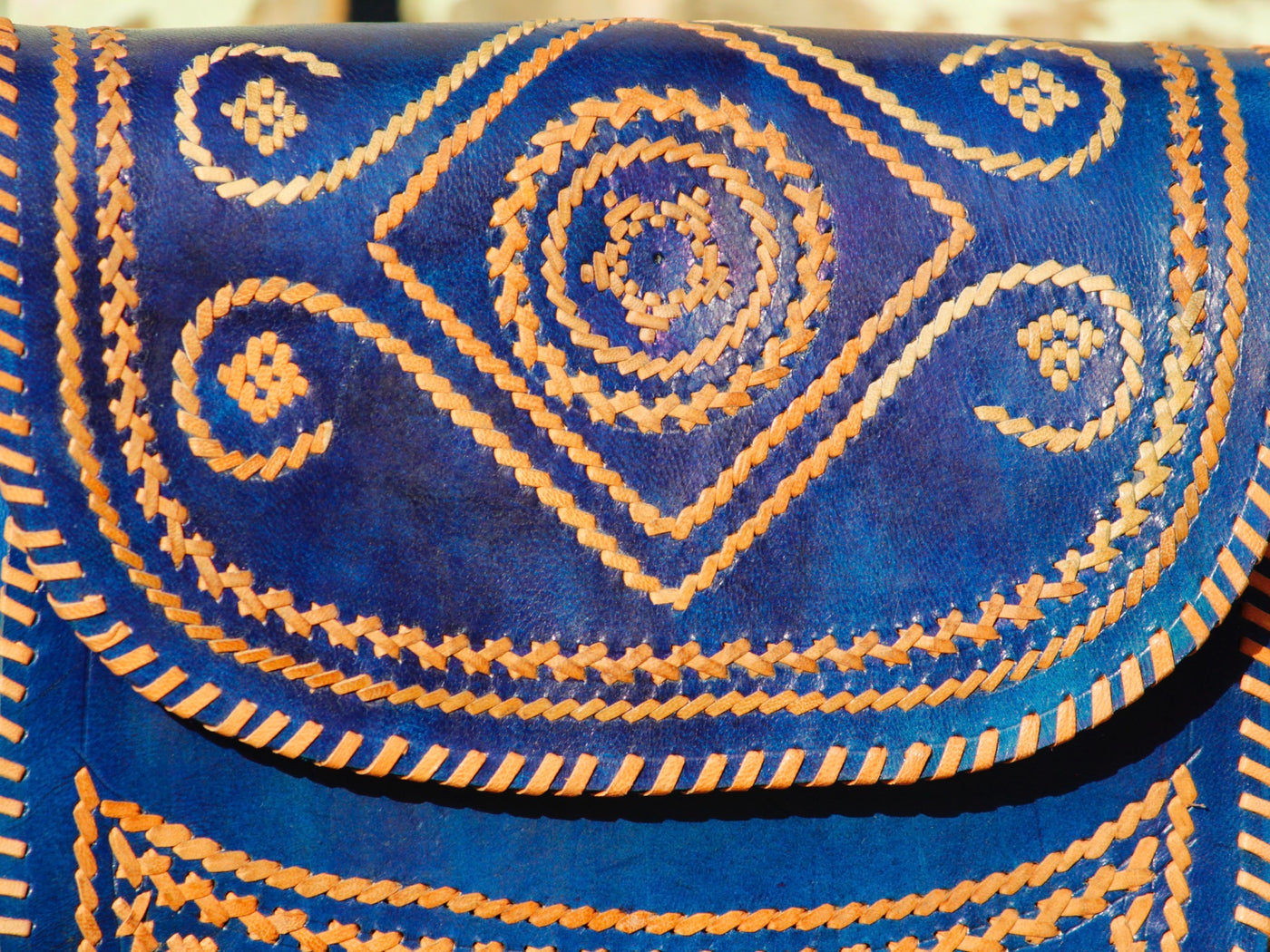 Elegant leather bag with embroidered accents and durable leather construction
