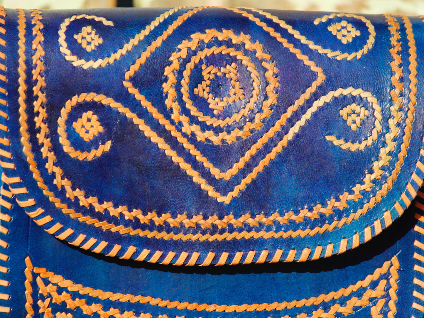 Elegant leather bag with embroidered accents and durable leather construction
