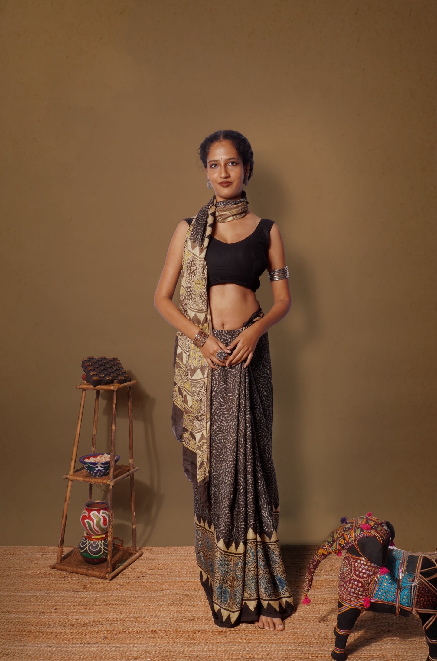 Espresso brown Ajrakh modal silk saree featuring intricate hand block printed motifs and a graceful drape