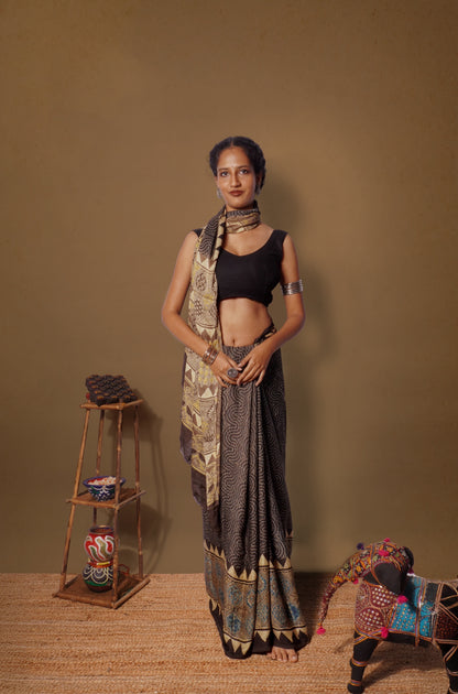 Espresso brown Ajrakh modal silk saree featuring intricate hand block printed motifs and a graceful drape