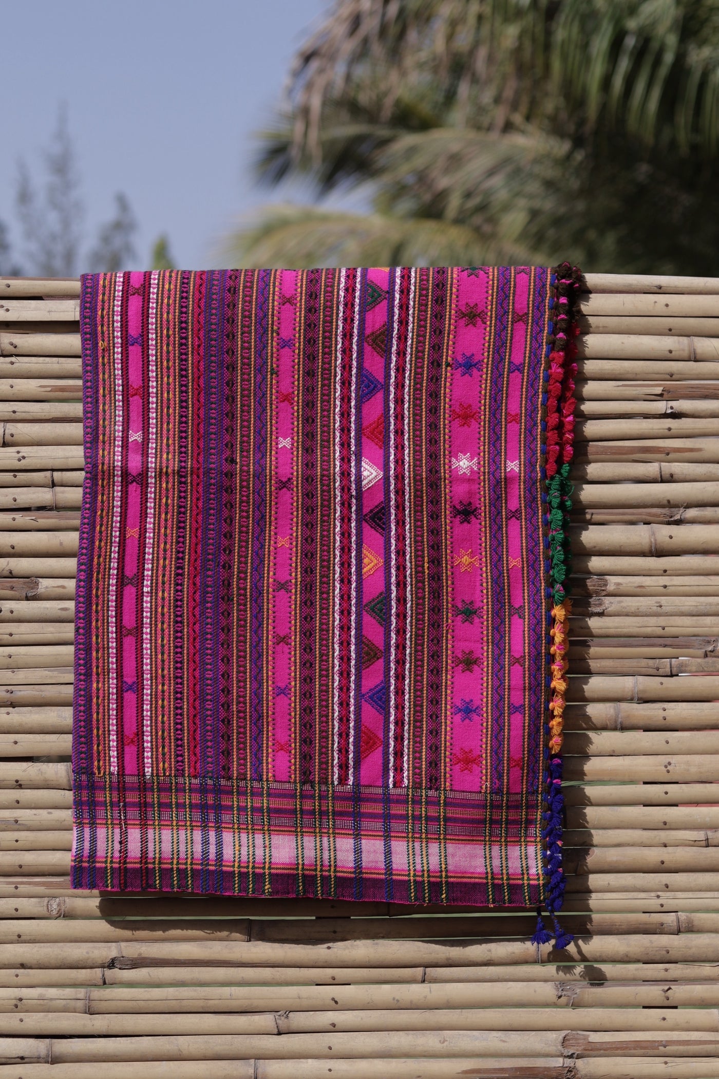 Fuchsia handwoven woolen shawl featuring a vibrant hue and exquisite artisan craftsmanship