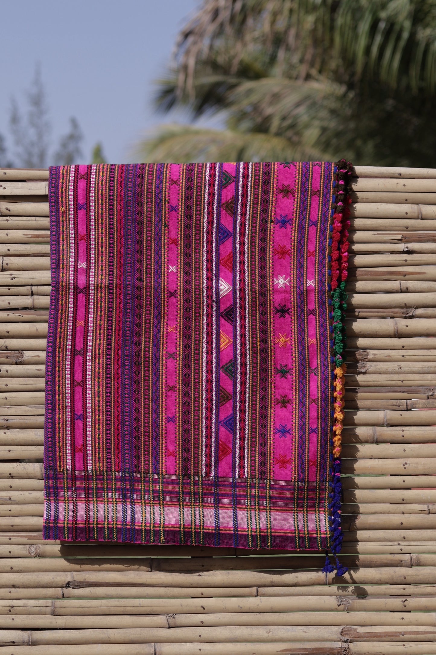 Fuchsia handwoven woolen shawl featuring a vibrant hue and exquisite artisan craftsmanship