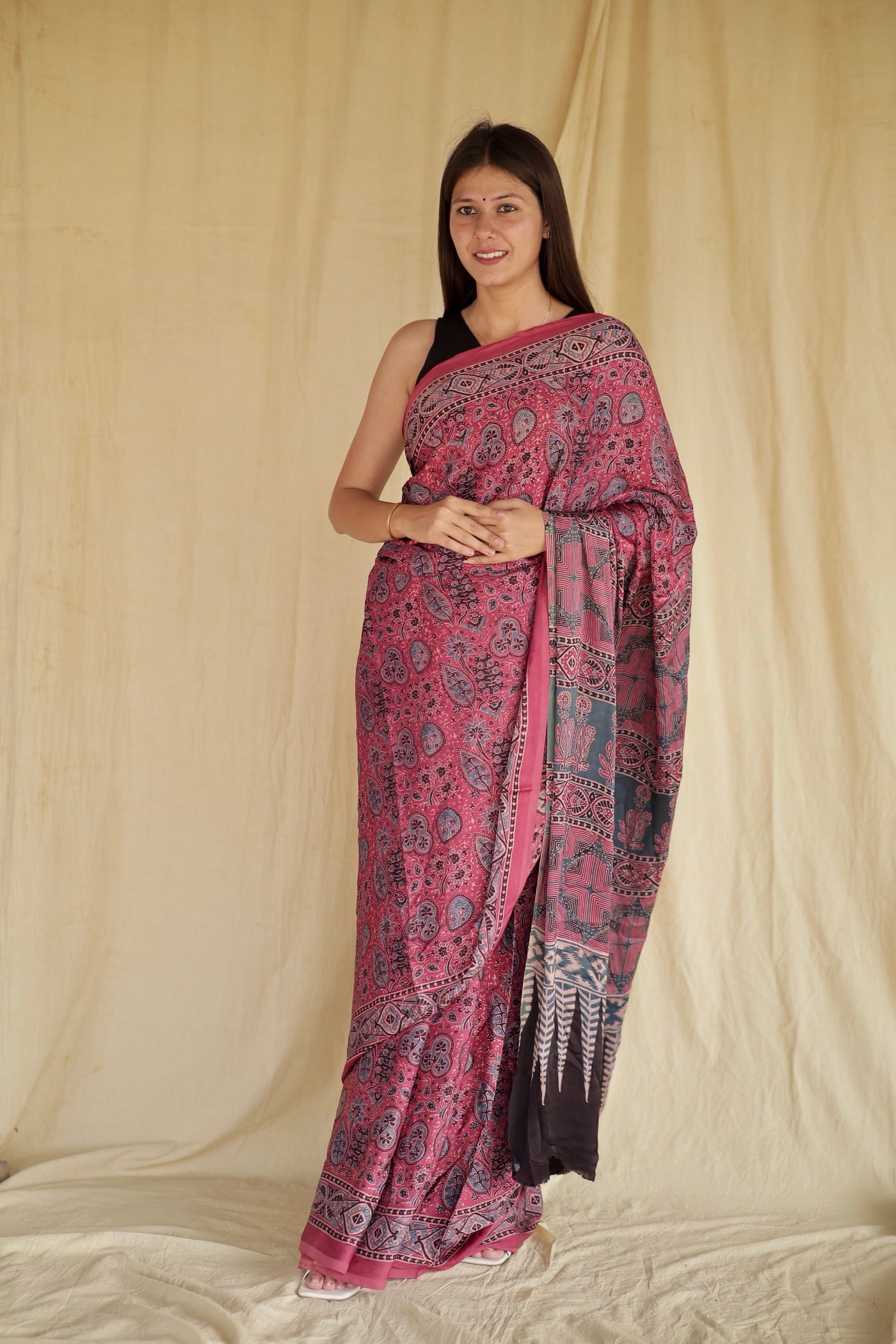 Fuchsia pink Ajrakh modal silk saree featuring intricate hand block printed motifs and a graceful drape