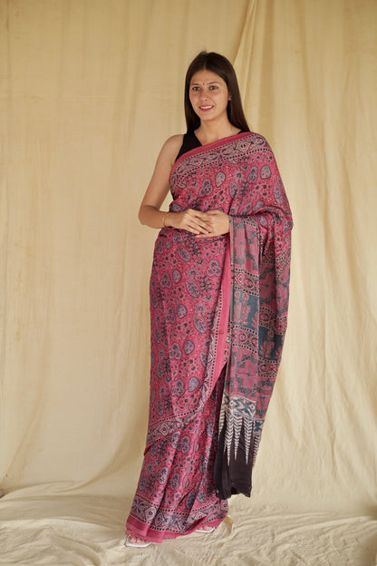Fuchsia pink Ajrakh modal silk saree featuring intricate hand block printed motifs and a graceful drape