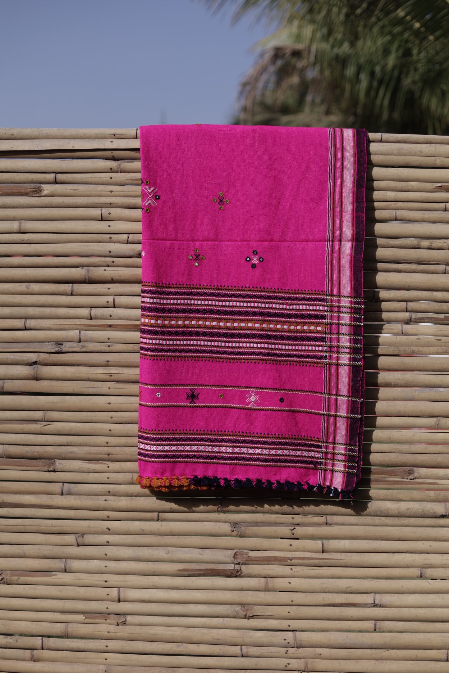 Fuchsia pink handwoven woolen shawl featuring a vibrant hue and exquisite artisan craftsmanship
