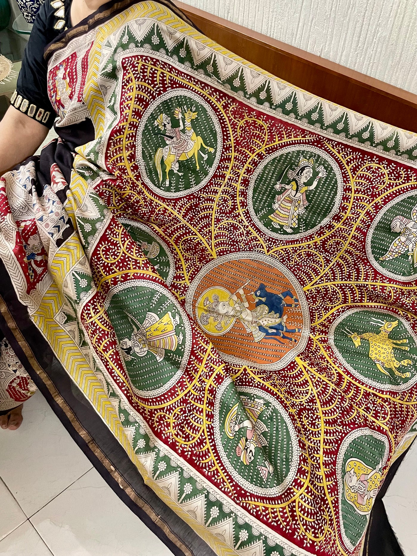 Traditional black Mata Ni Pachedi saree with vibrant handpainted motifs and graceful artisanal craftsmanship
