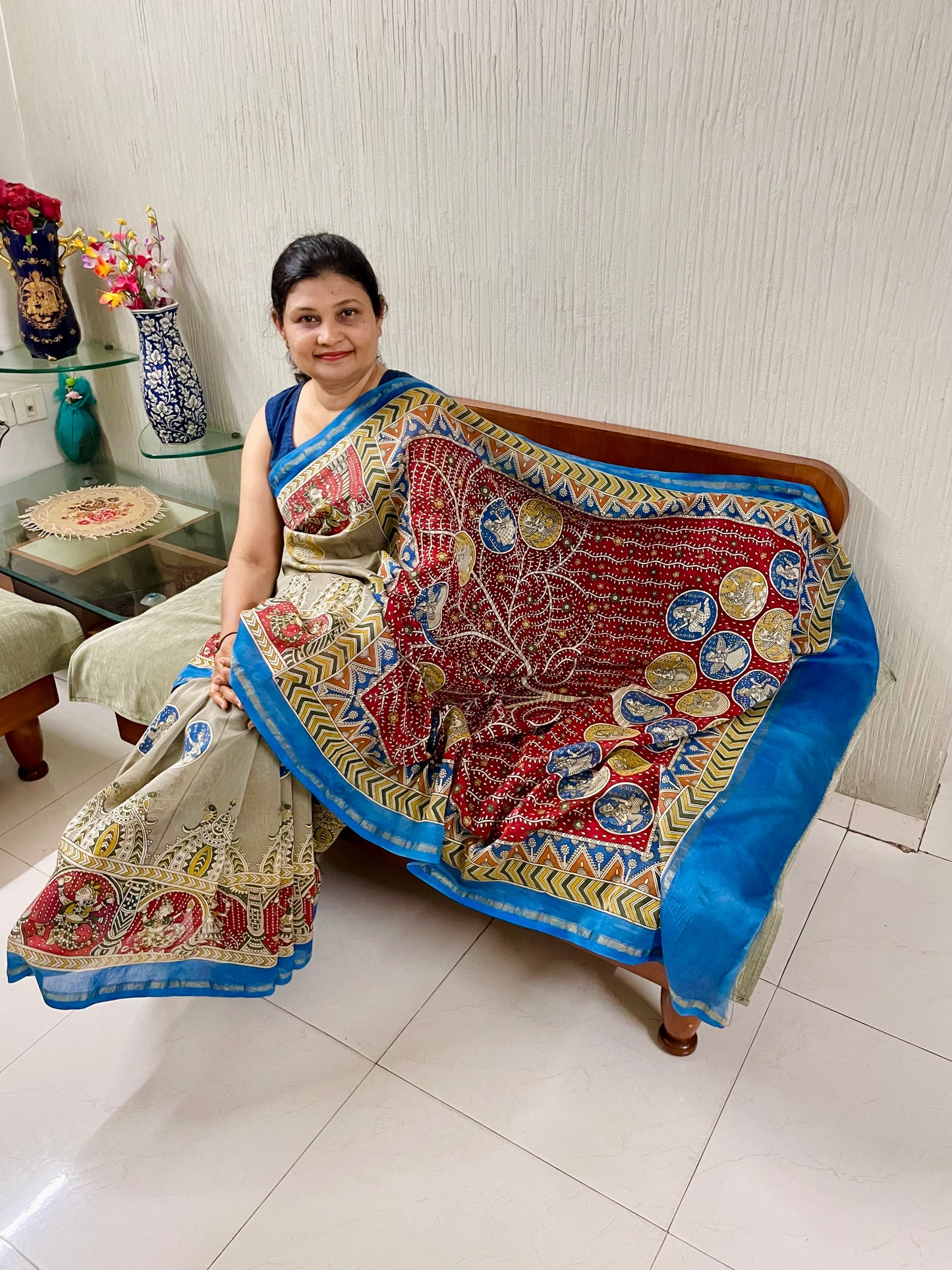 Traditional creamy red Mata Ni Pachedi saree with vibrant handpainted motifs and graceful artisanal craftsmanship