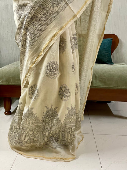 Traditional ivory white Mata Ni Pachedi saree with vibrant handpainted motifs and graceful artisanal craftsmanship