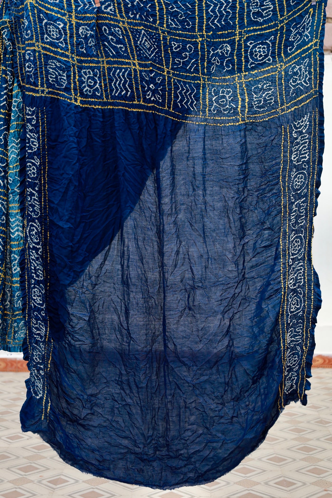 Premium midnight blue Bandhani silk saree highlighting fine artisan craftsmanship and festive elegance