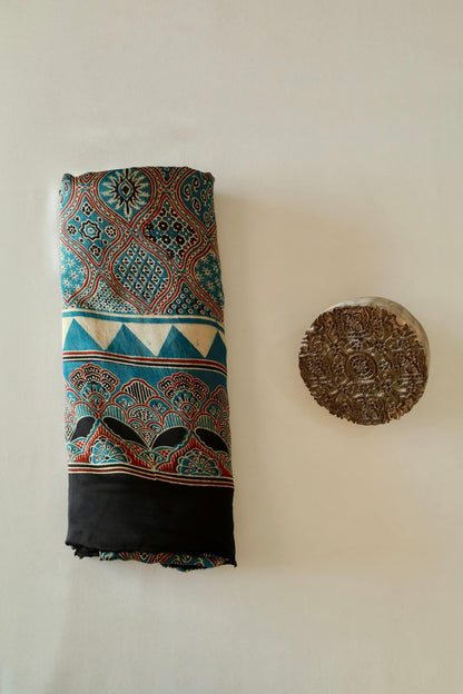 Traditional ocean blue Ajrakh modal silk saree with rich artisanal prints and a soft flowing texture