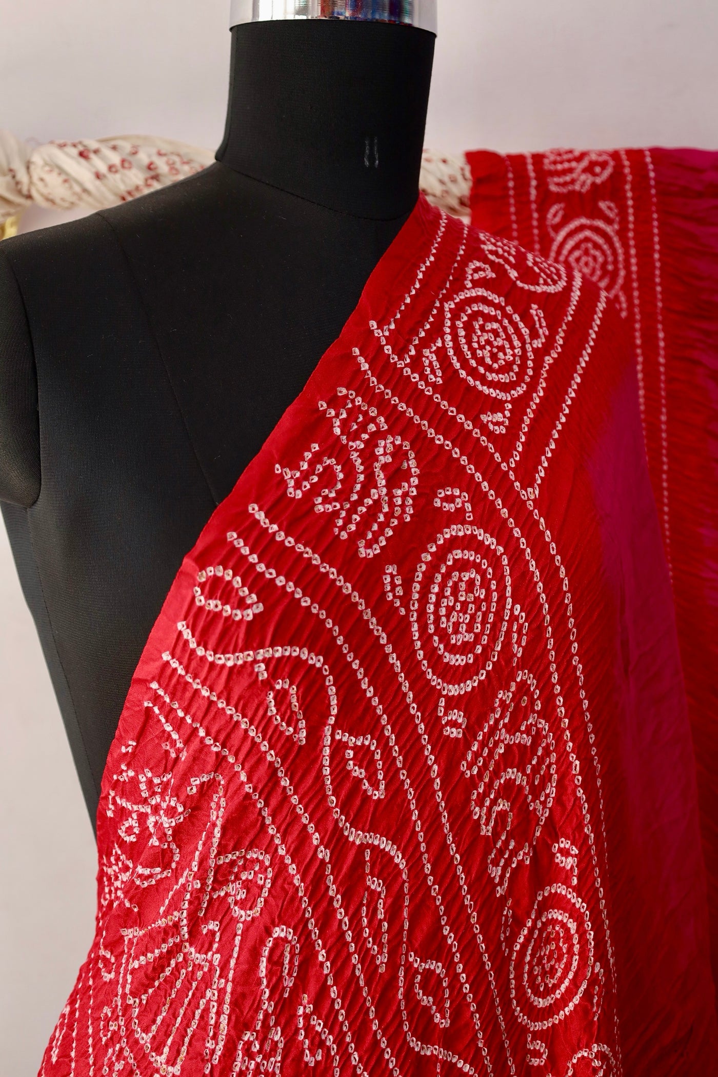 Traditional Bandhani Gajji silk saree in ruby hues with a beautifully woven zari pallu