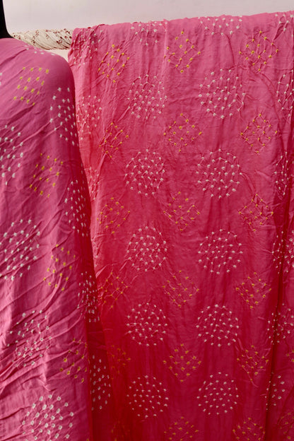 Soft pink Bandhani Gajji silk saree featuring intricate tie-dye patterns and an elegant zari pallu. Handcrafted soft pink Gajji silk saree showcasing authentic Bandhani artistry with rich zari detailing