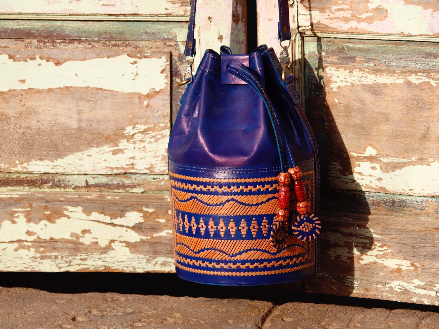 Leather potli bag adorned with intricate thread work on premium handcrafted leather