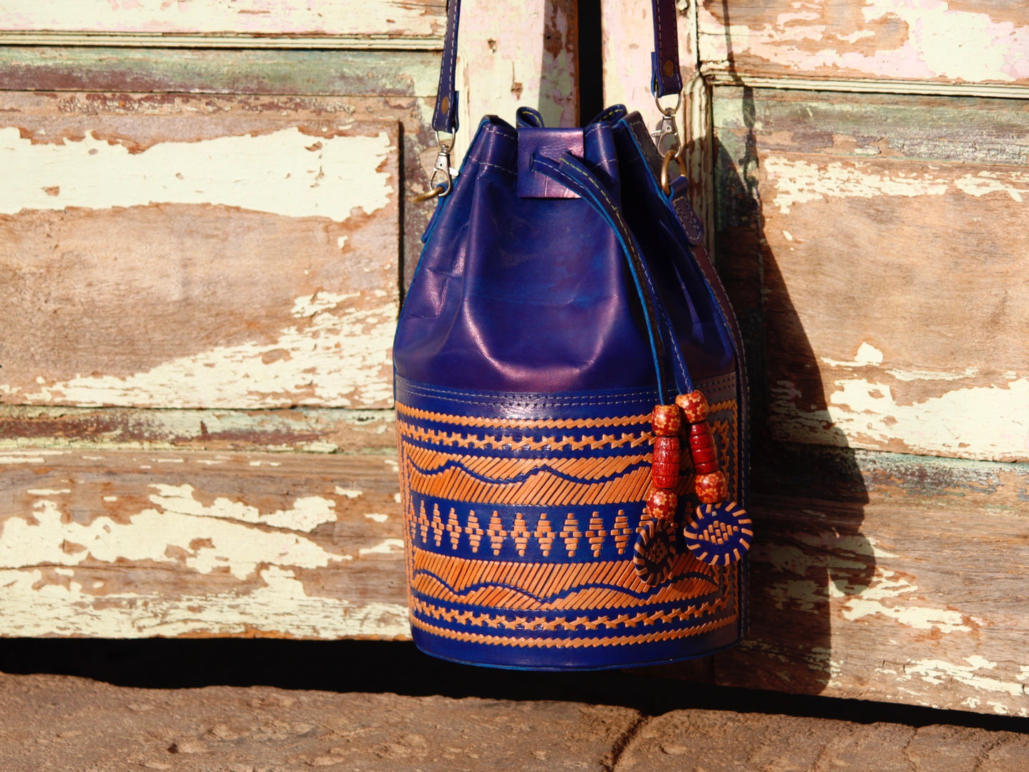 Leather potli bag adorned with intricate thread work on premium handcrafted leather