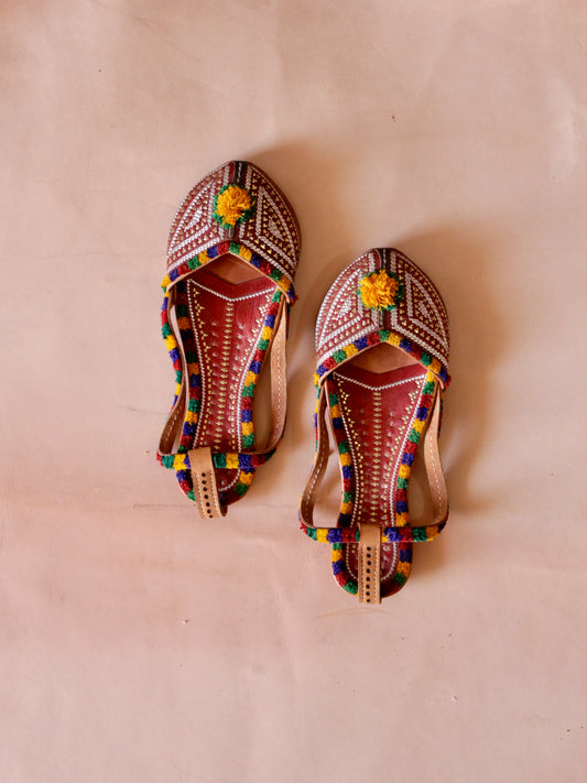 Handstitched leather jutti showcasing traditional artisan craftsmanship and timeless design