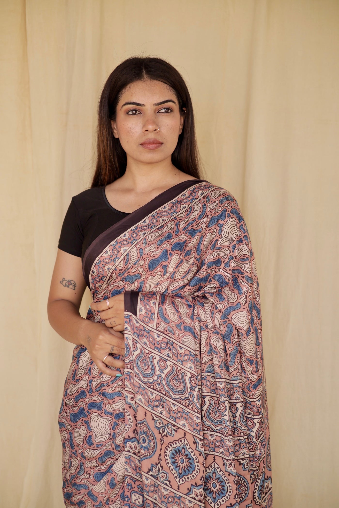 Handcrafted antique rose modal silk saree adorned with traditional Ajrakh patterns and elegant detailing