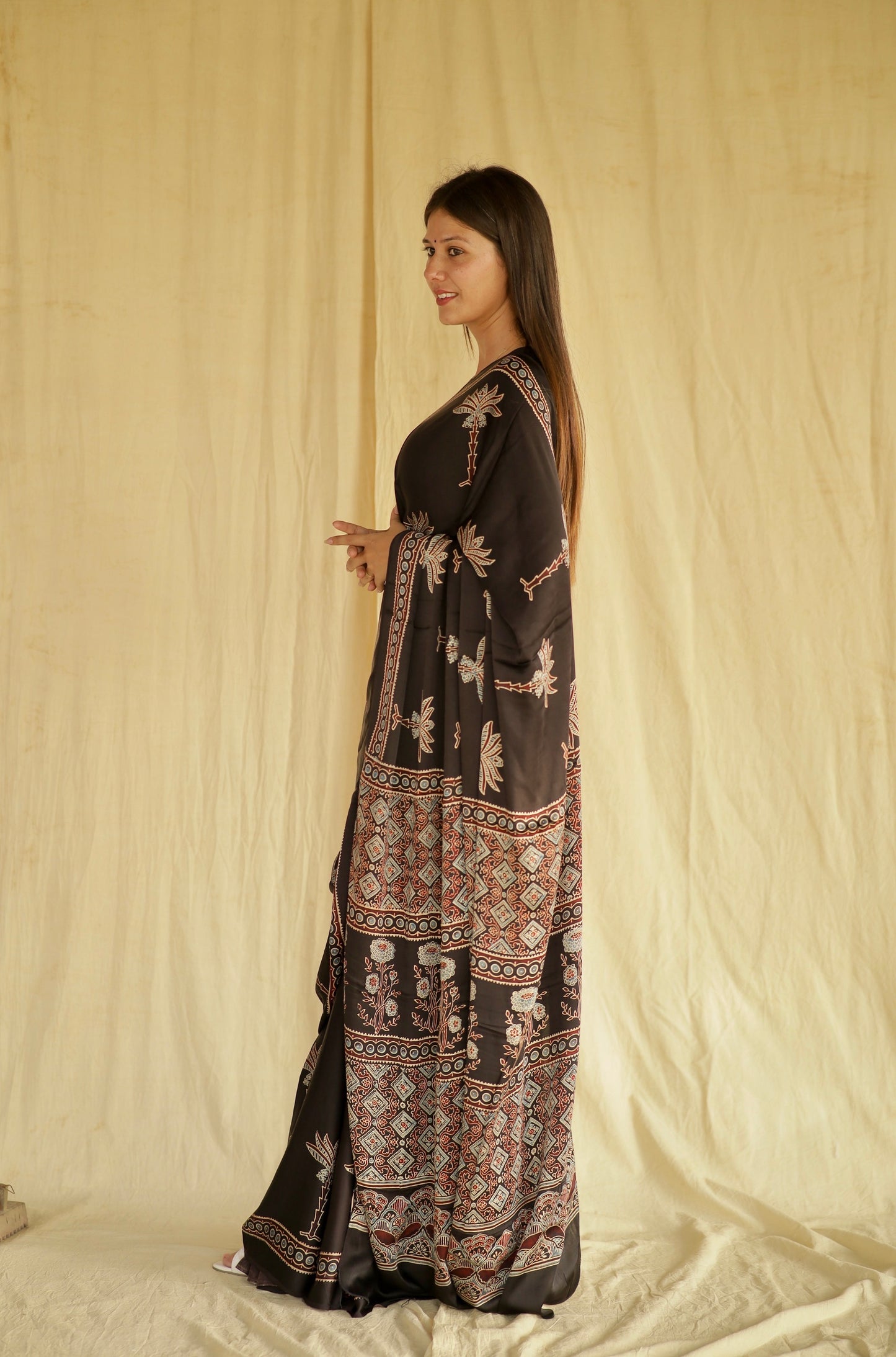 Handcrafted black modal silk saree adorned with traditional Ajrakh lotus patterns and refined detailing