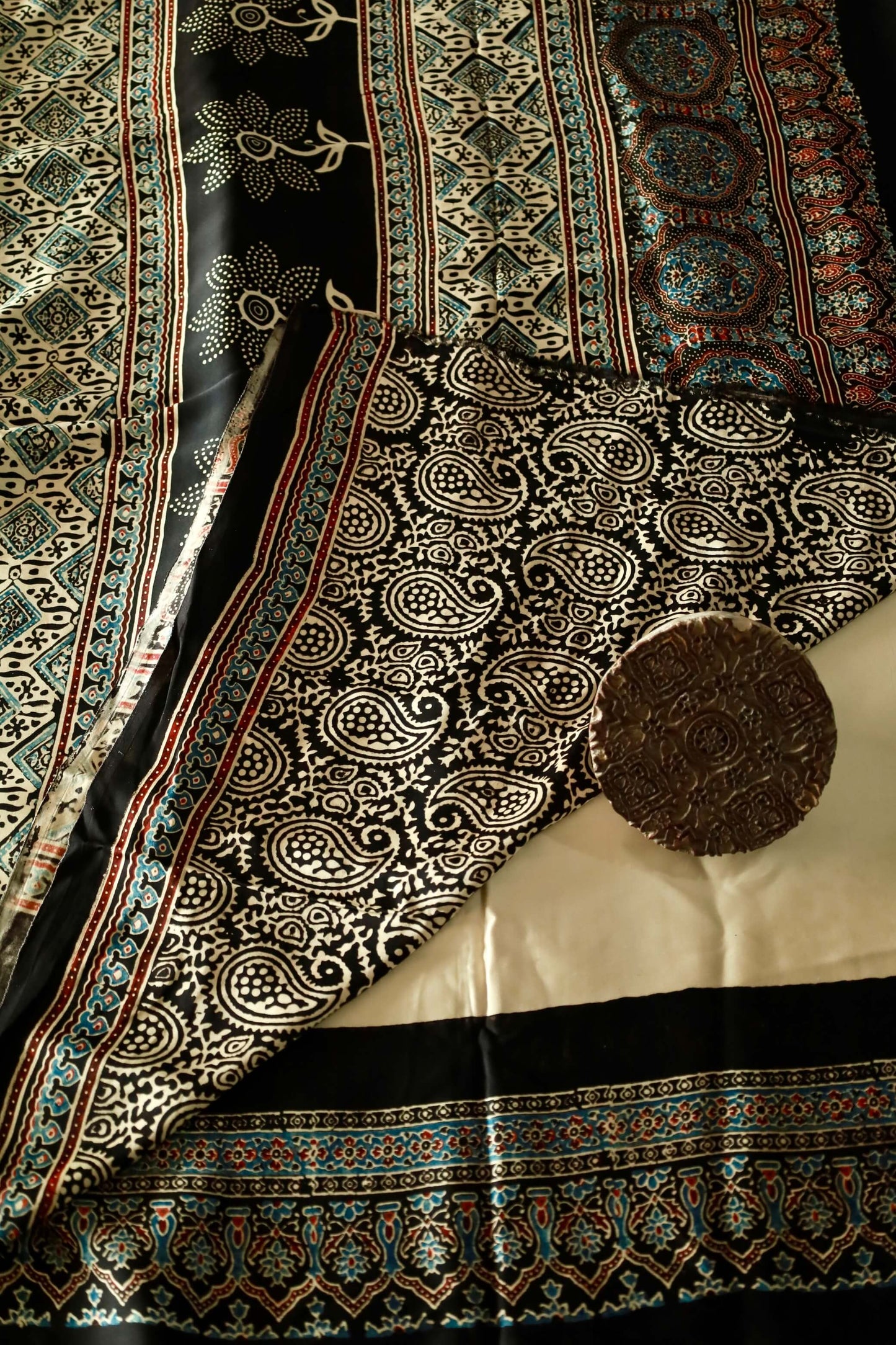 Handcrafted black sunflower modal silk saree adorned with traditional Ajrakh patterns and floral-inspired detailing