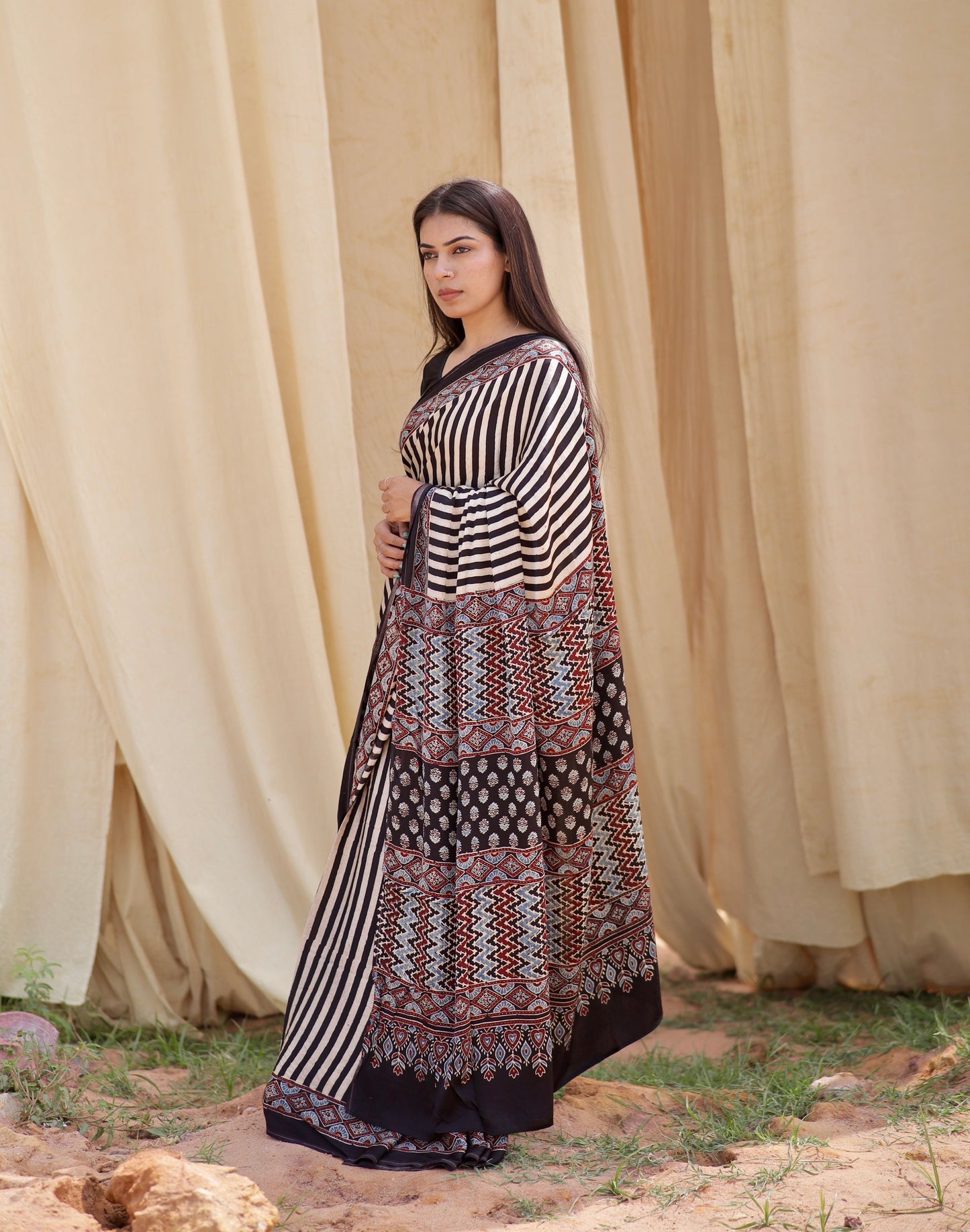 Handcrafted black and white striped modal silk saree adorned with traditional Ajrakh patterns and refined detailing
