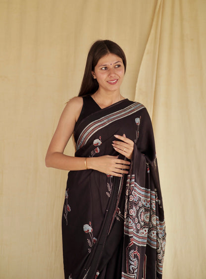 Handcrafted charcoal black modal silk saree adorned with traditional Ajrakh patterns and luxurious texture
