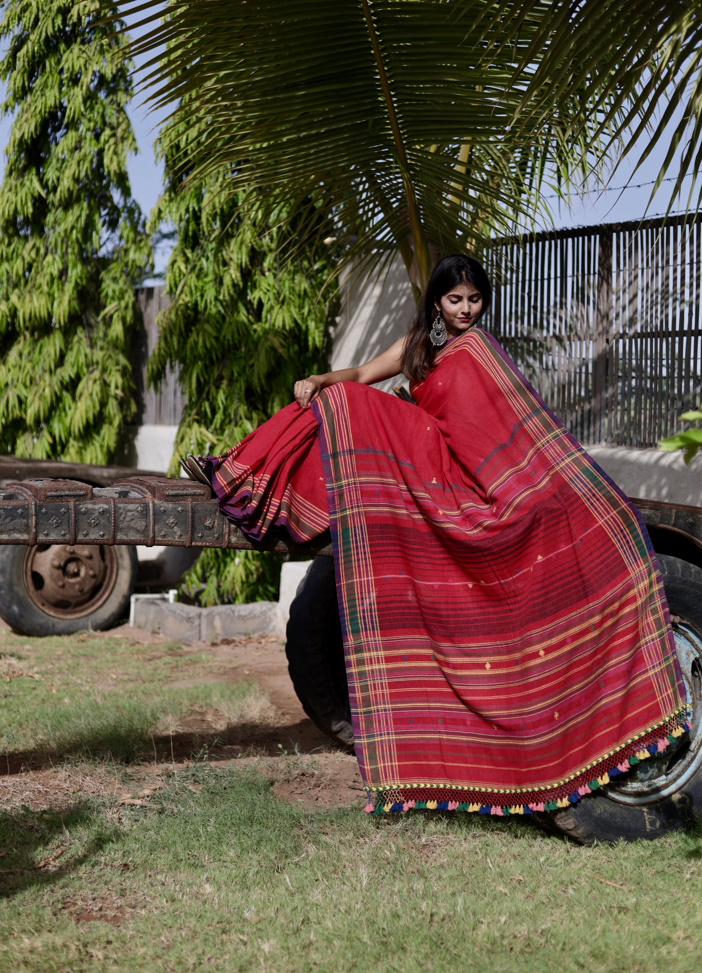 Handcrafted cherry Kala Cotton saree adorned with authentic Bhujodi weaving and heritage-inspired motifs