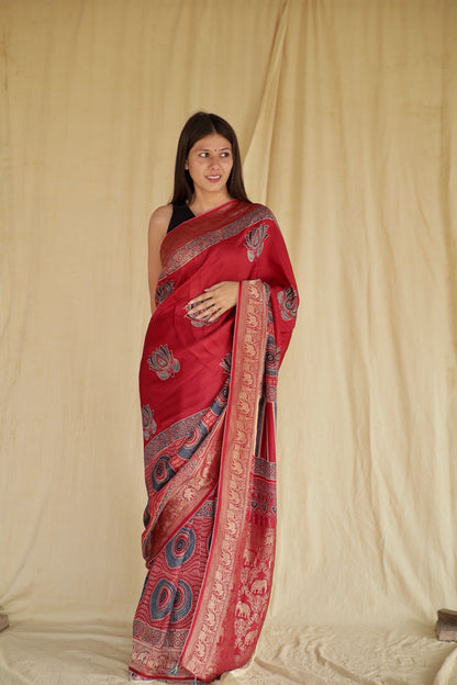 Crimson red handcrafted Dola silk saree with traditional Ajrakh patterns and luxurious texture