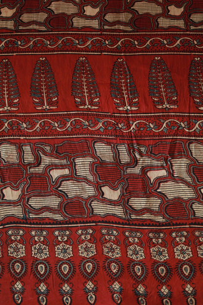 Handcrafted crimson red modal silk saree adorned with traditional Ajrakh patterns and artisanal detailing