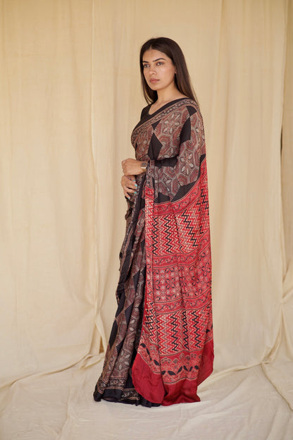 Handcrafted dark mocha modal silk saree adorned with traditional Ajrakh patterns and refined detailing