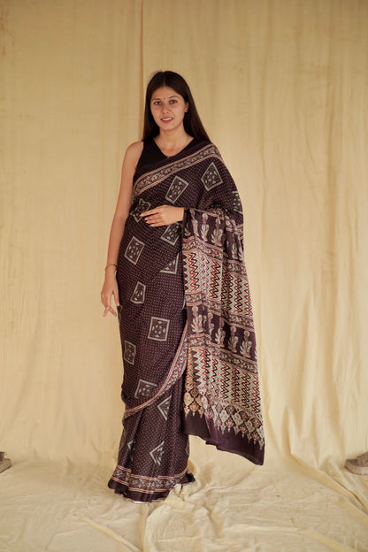 Handcrafted deep black modal silk saree adorned with traditional Ajrakh patterns and artisanal detailing