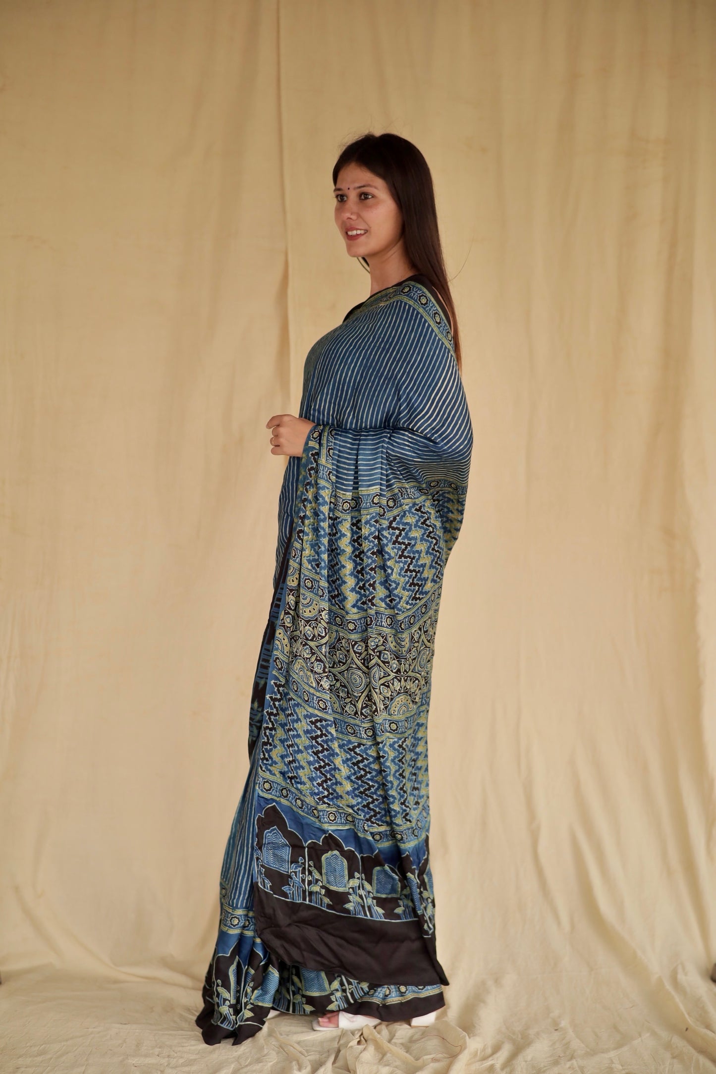 Handcrafted denim blue modal silk saree adorned with traditional Ajrakh patterns and refined detailing