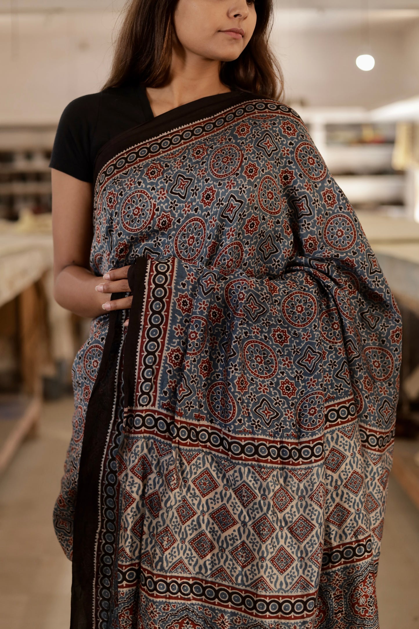Handcrafted dusty blue modal silk saree adorned with traditional Ajrakh patterns and artisanal detailing