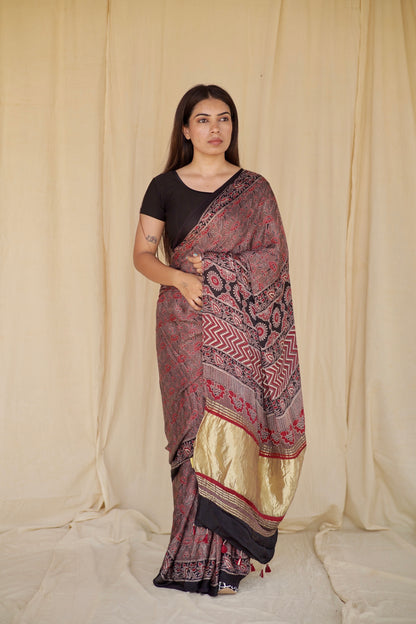 Handcrafted dusty rose modal silk saree adorned with traditional Ajrakh patterns and soft luxurious texture