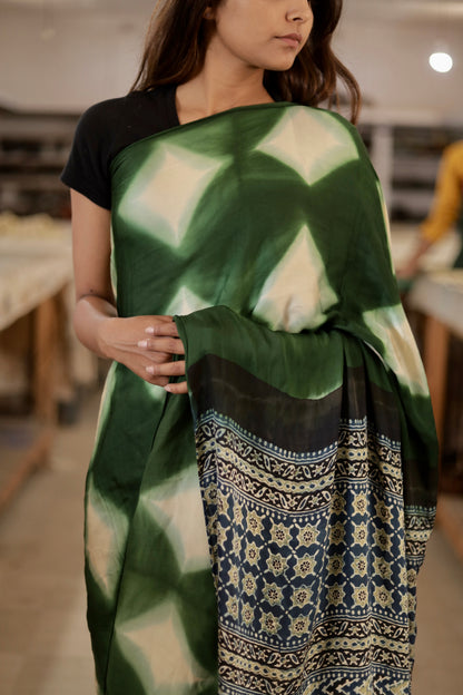 Handcrafted emerald green modal silk saree with traditional Ajrakh motifs, clamp dyeing, and zari detailing