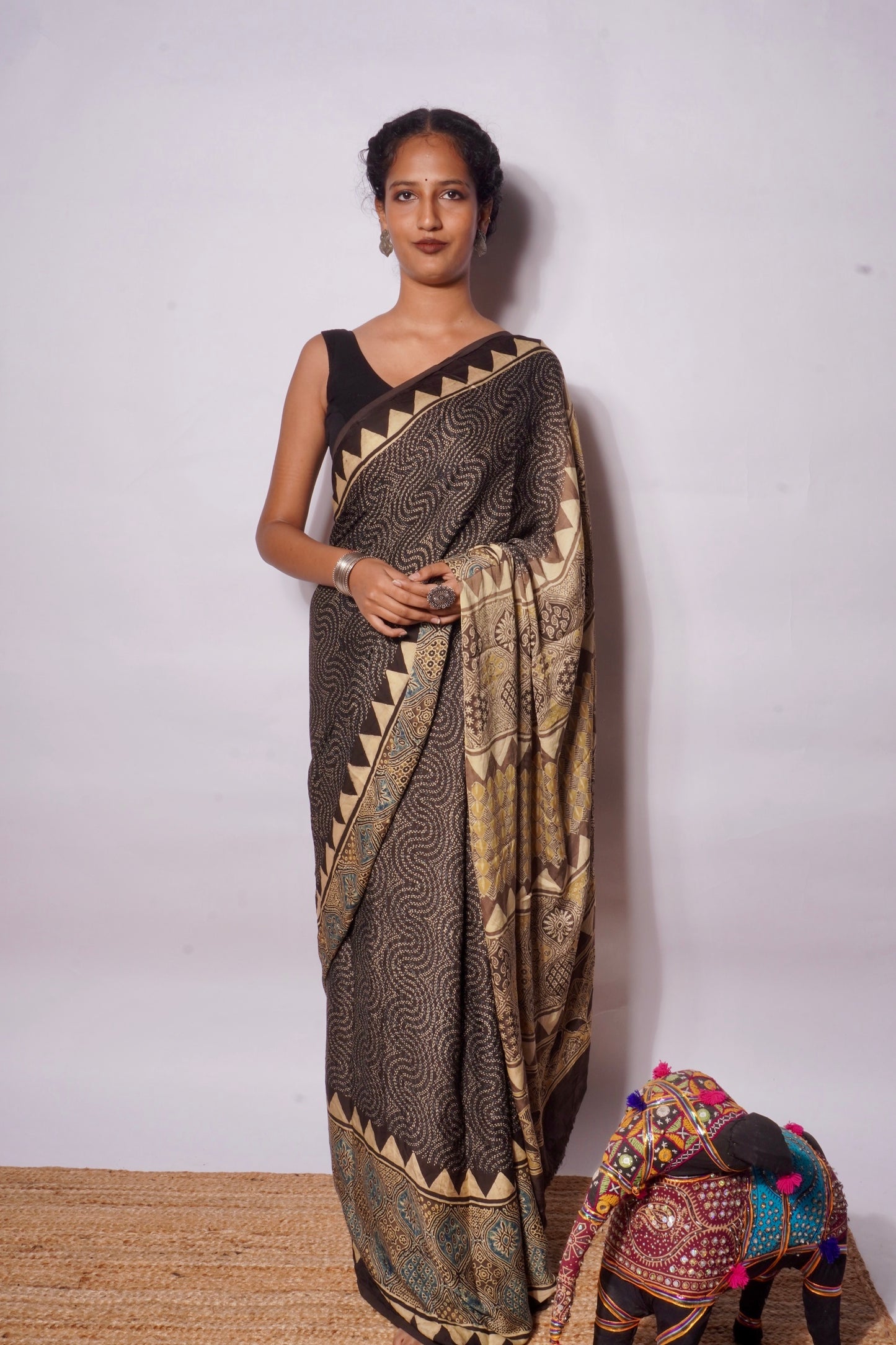 Handcrafted espresso brown modal silk saree adorned with traditional Ajrakh patterns and refined detailing