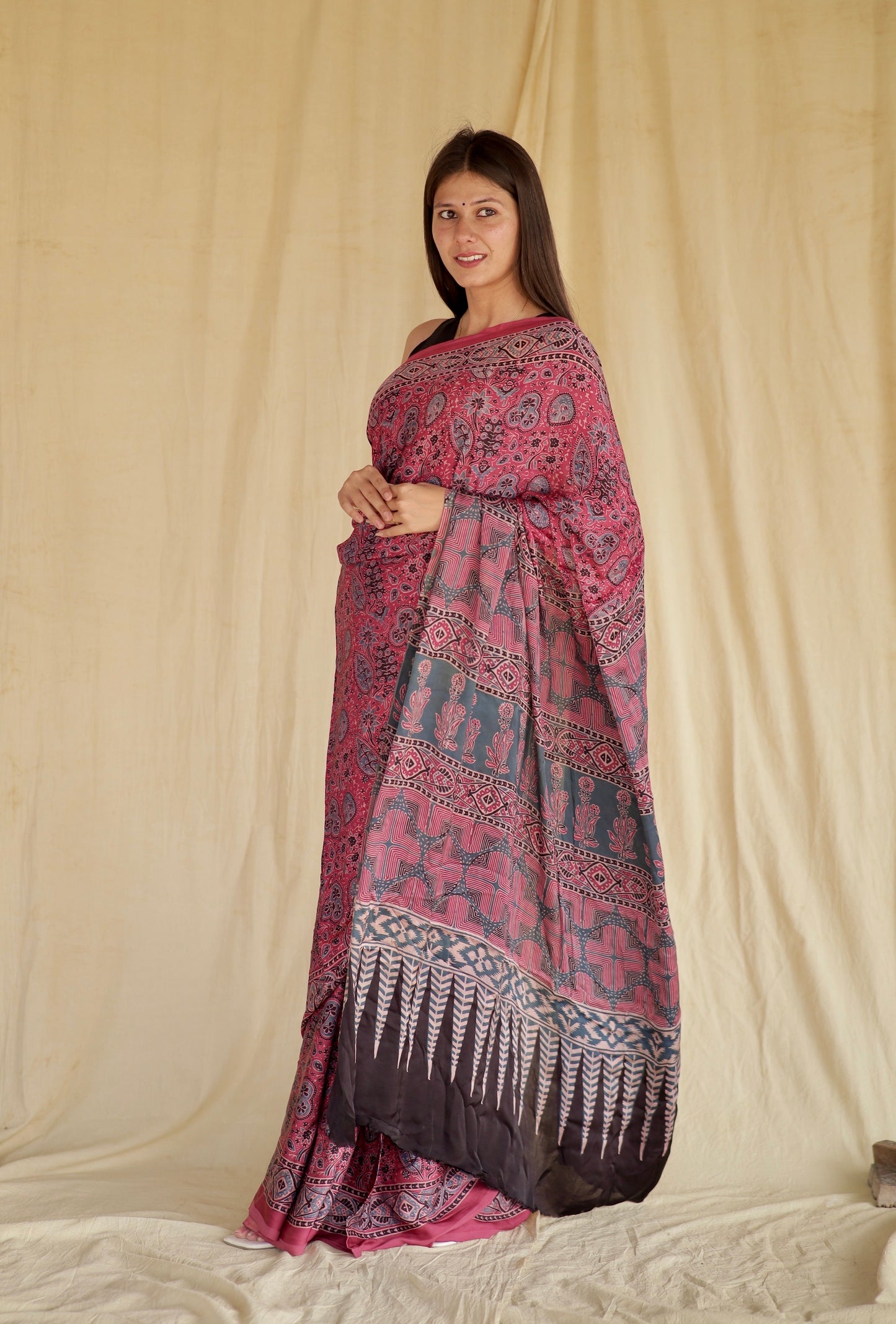 Handcrafted fuchsia pink modal silk saree adorned with traditional Ajrakh patterns and vibrant detailing