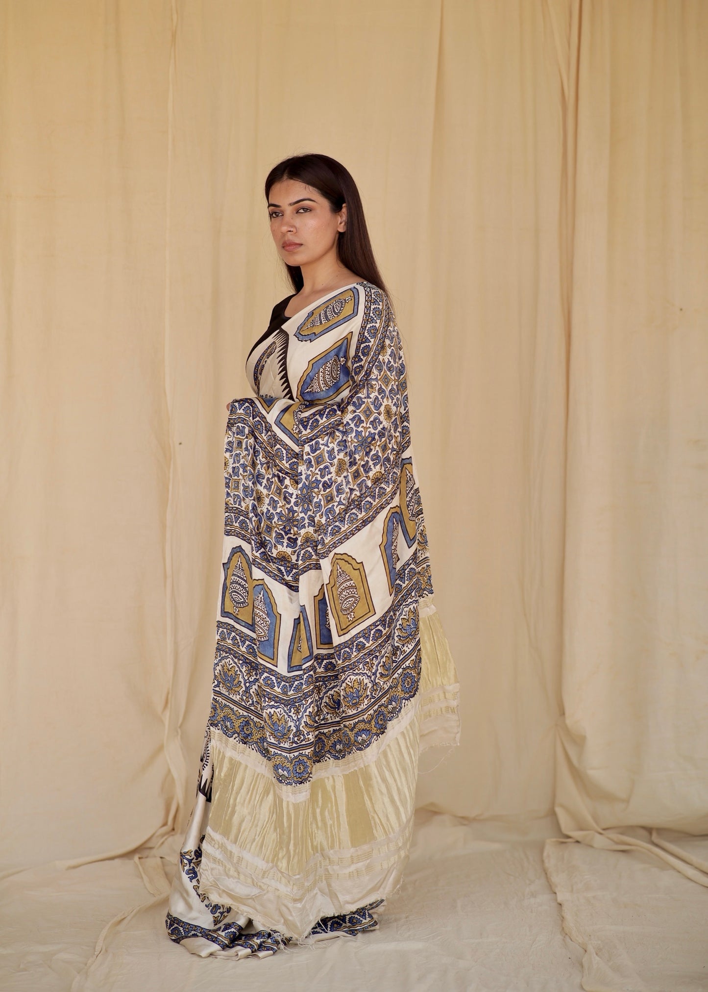 Handcrafted ivory white modal silk saree adorned with traditional Ajrakh patterns and elegant detailing