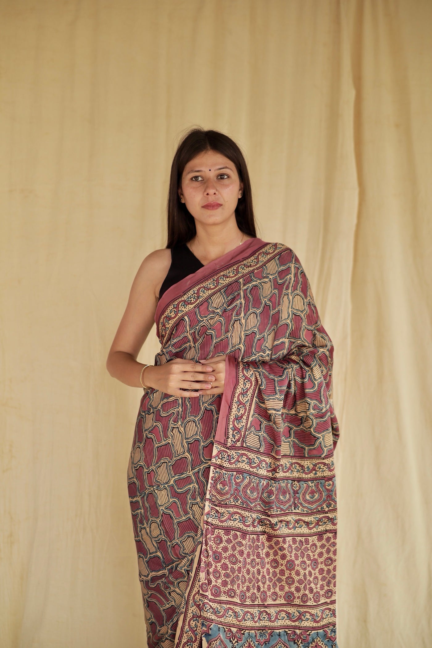 Handcrafted mauve pink modal silk saree adorned with traditional Ajrakh patterns and soft luxurious texture