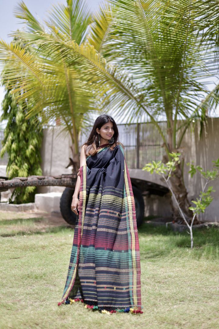 Handcrafted midnight Kala Cotton saree adorned with authentic Bhujodi weaving and heritage-inspired motifs