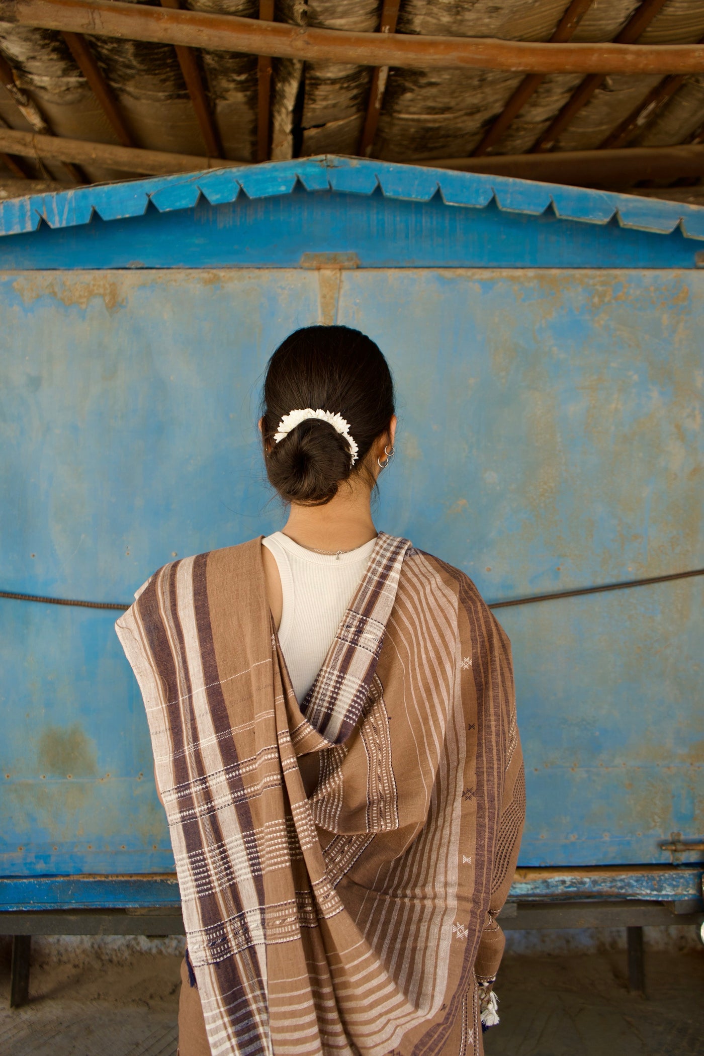 Handcrafted mocha Kala Cotton saree adorned with authentic Bhujodi weaving and heritage-inspired motifs