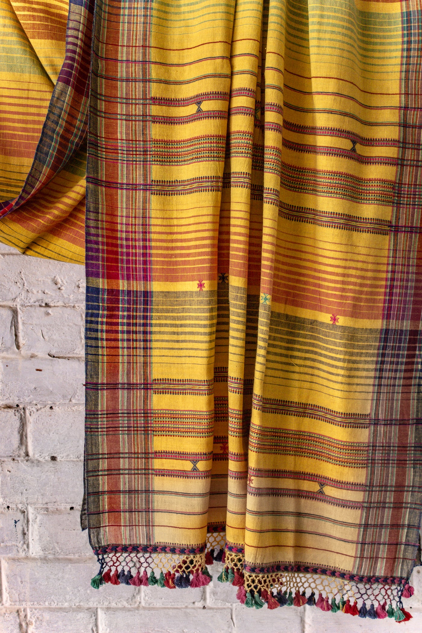 Handcrafted mustard Kala Cotton saree adorned with authentic Bhujodi weaving and heritage-inspired motifs
