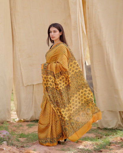 Handcrafted mustard yellow Chanderi silk saree adorned with traditional Ajrakh patterns and delicate texture