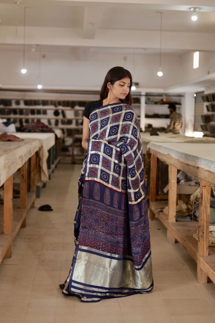 Navy blue Gharchola Ajrakh modal silk saree featuring traditional motifs and a graceful drape