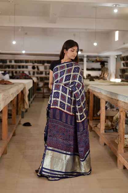 Navy blue Gharchola Ajrakh modal silk saree featuring traditional motifs and a graceful drape