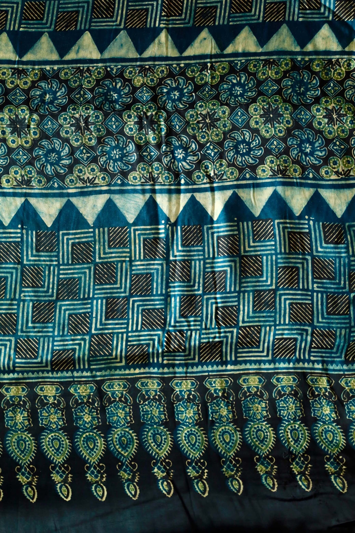 Handcrafted navy teal modal silk saree adorned with traditional Ajrakh patterns and artisanal detailing