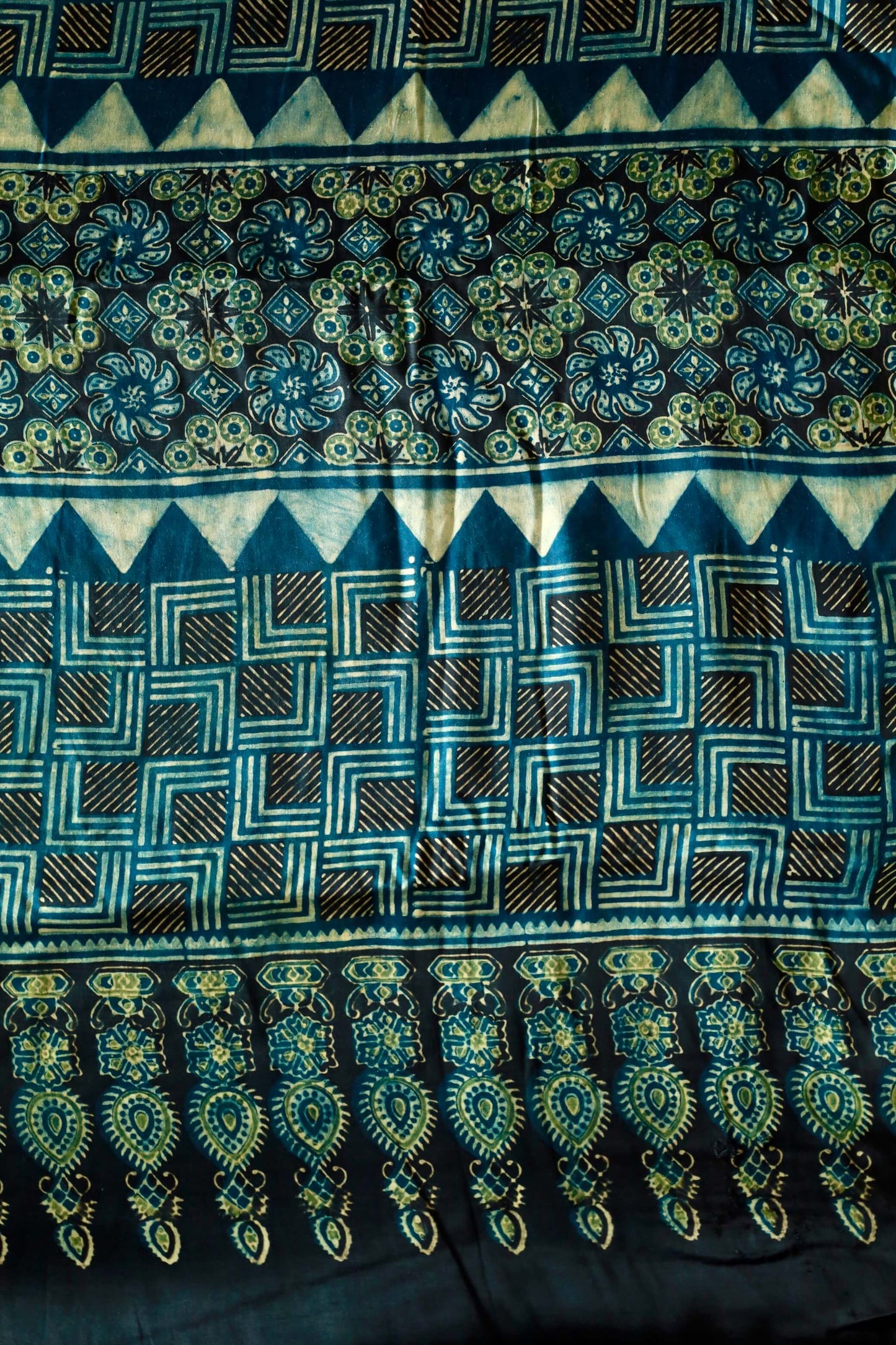 Handcrafted navy teal modal silk saree adorned with traditional Ajrakh patterns and artisanal detailing