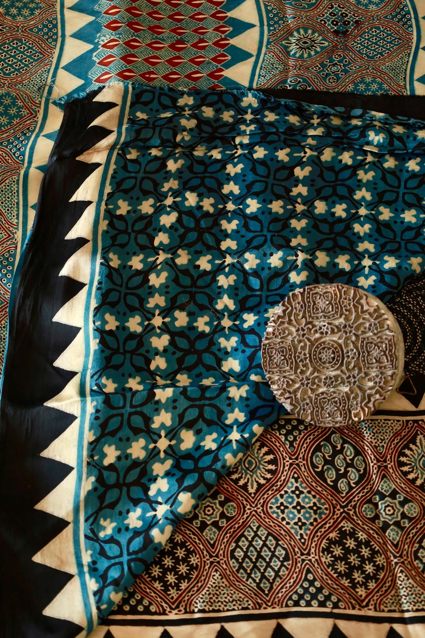 Handcrafted ocean blue modal silk saree adorned with traditional Ajrakh patterns and artisanal detailing